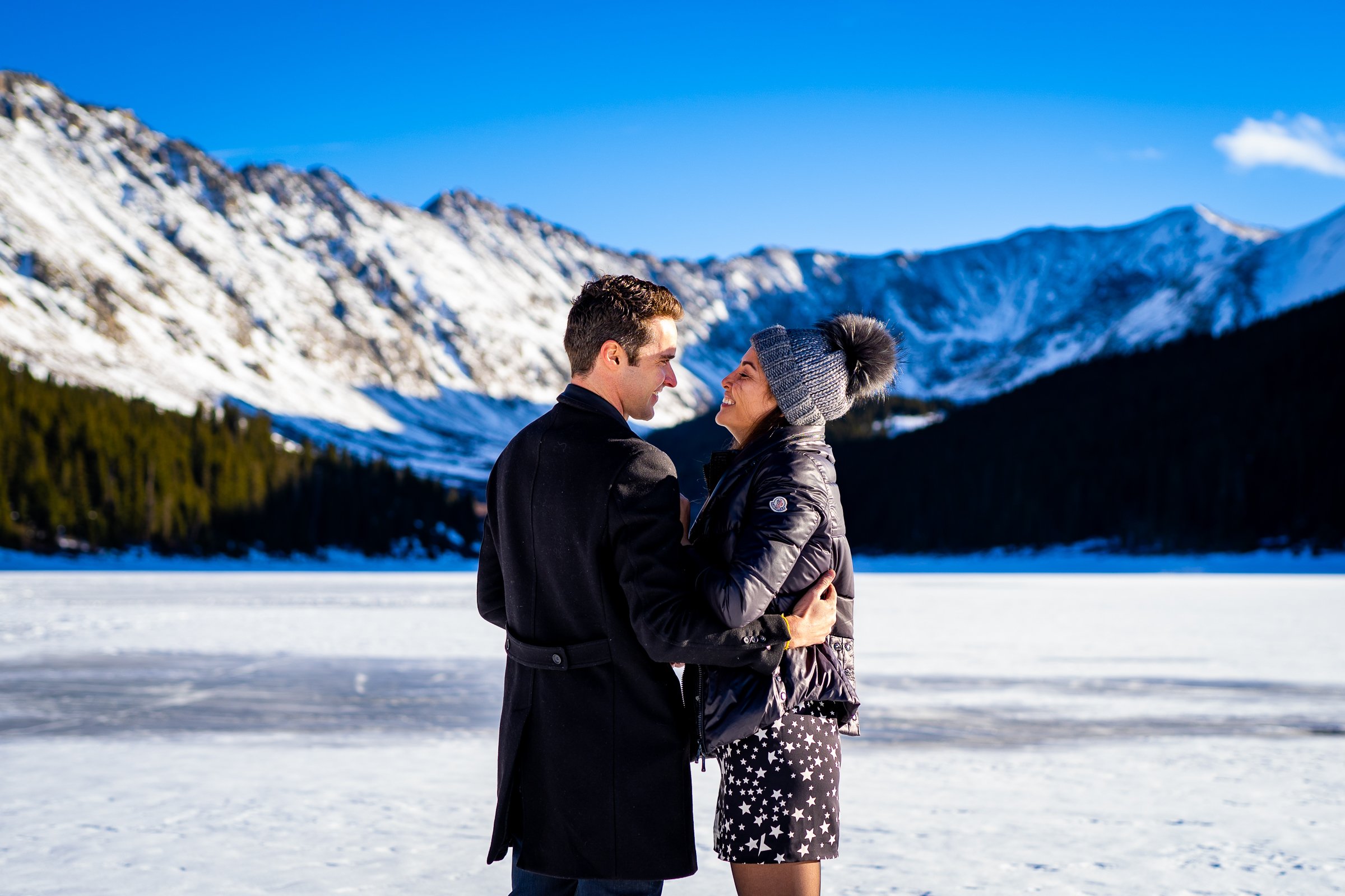 Man proposes to girlfriend while standing on a frozen lake with snowcapped mountains in the background, Engagement Session, Engagement Photos, Engagement Photos Inspiration, Engagement Photography, Engagement Photographer, Winter Engagement Photos, Proposal Photos, Proposal Photographer, Proposal Photography, Winter Proposal, Mountain Proposal, Proposal Inspiration, Summit County engagement session, Summit County engagement photos, Summit County engagement photography, Summit County engagement photographer, Summit County engagement inspiration, Colorado engagement session, Colorado engagement photos, Colorado engagement photography, Colorado engagement photographer, Colorado engagement inspiration, Clinton Gulch Engagement