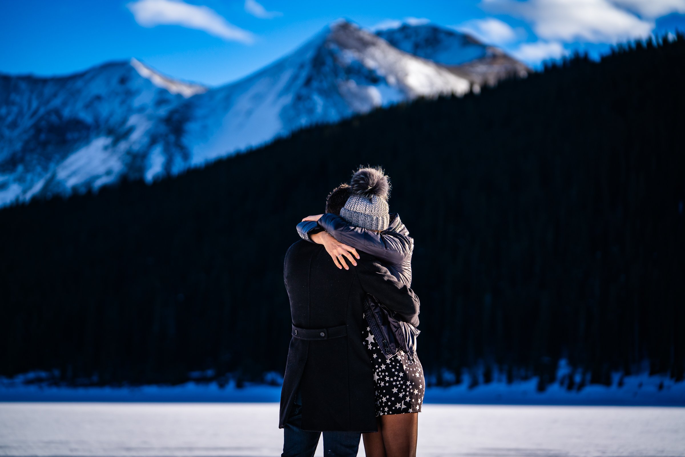 Man proposes to girlfriend while standing on a frozen lake with snowcapped mountains in the background, Engagement Session, Engagement Photos, Engagement Photos Inspiration, Engagement Photography, Engagement Photographer, Winter Engagement Photos, Proposal Photos, Proposal Photographer, Proposal Photography, Winter Proposal, Mountain Proposal, Proposal Inspiration, Summit County engagement session, Summit County engagement photos, Summit County engagement photography, Summit County engagement photographer, Summit County engagement inspiration, Colorado engagement session, Colorado engagement photos, Colorado engagement photography, Colorado engagement photographer, Colorado engagement inspiration, Clinton Gulch Engagement