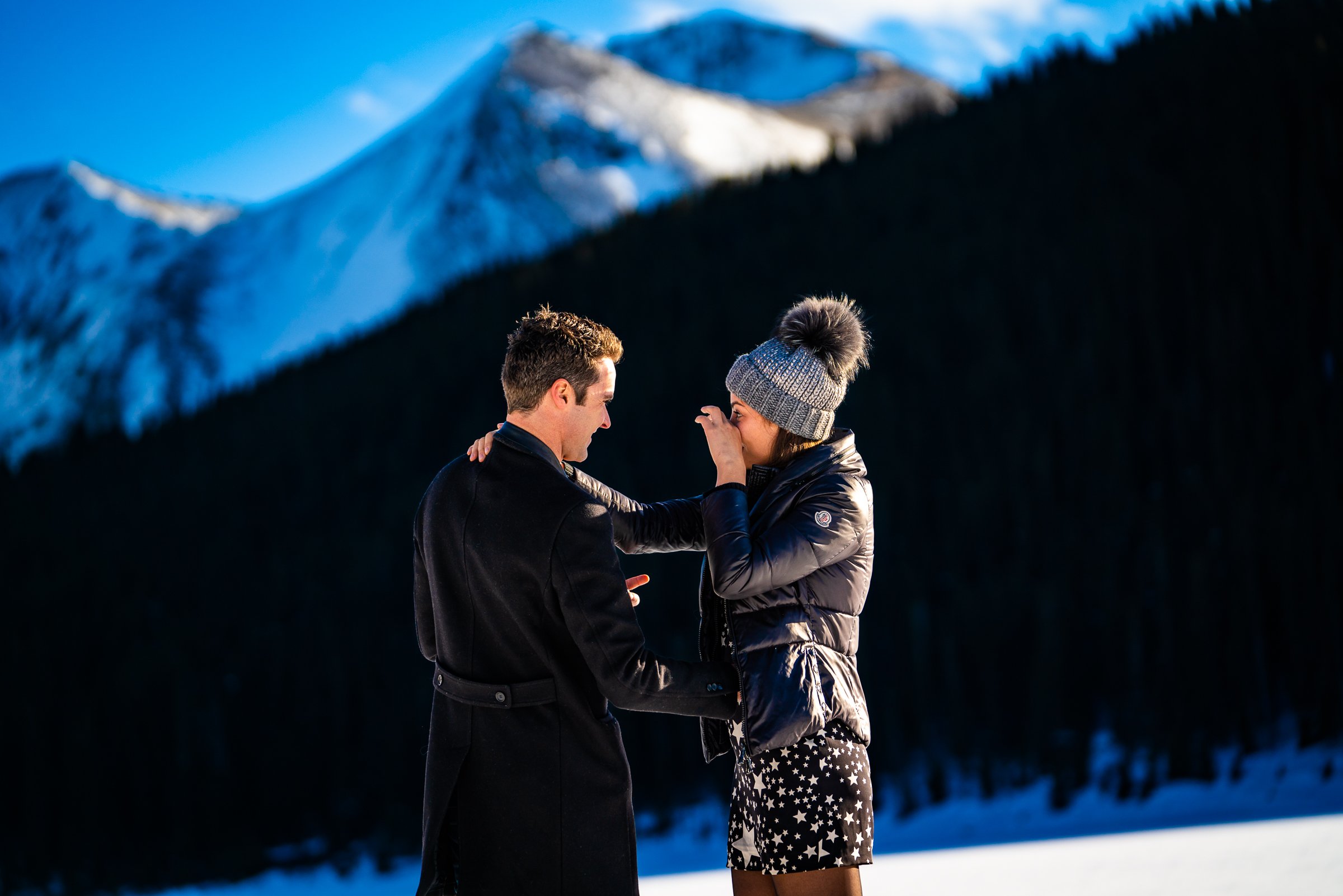 Man proposes to girlfriend while standing on a frozen lake with snowcapped mountains in the background, Engagement Session, Engagement Photos, Engagement Photos Inspiration, Engagement Photography, Engagement Photographer, Winter Engagement Photos, Proposal Photos, Proposal Photographer, Proposal Photography, Winter Proposal, Mountain Proposal, Proposal Inspiration, Summit County engagement session, Summit County engagement photos, Summit County engagement photography, Summit County engagement photographer, Summit County engagement inspiration, Colorado engagement session, Colorado engagement photos, Colorado engagement photography, Colorado engagement photographer, Colorado engagement inspiration, Clinton Gulch Engagement