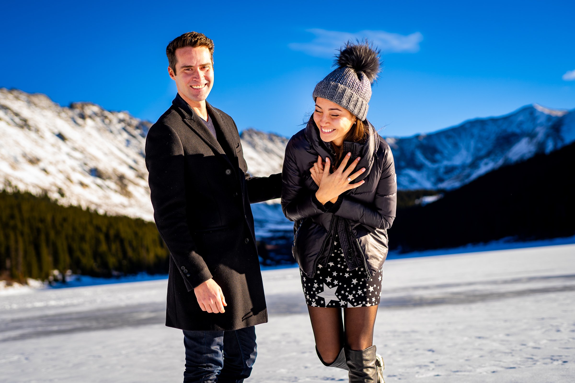 Man proposes to girlfriend while standing on a frozen lake with snowcapped mountains in the background, Engagement Session, Engagement Photos, Engagement Photos Inspiration, Engagement Photography, Engagement Photographer, Winter Engagement Photos, Proposal Photos, Proposal Photographer, Proposal Photography, Winter Proposal, Mountain Proposal, Proposal Inspiration, Summit County engagement session, Summit County engagement photos, Summit County engagement photography, Summit County engagement photographer, Summit County engagement inspiration, Colorado engagement session, Colorado engagement photos, Colorado engagement photography, Colorado engagement photographer, Colorado engagement inspiration, Clinton Gulch Engagement