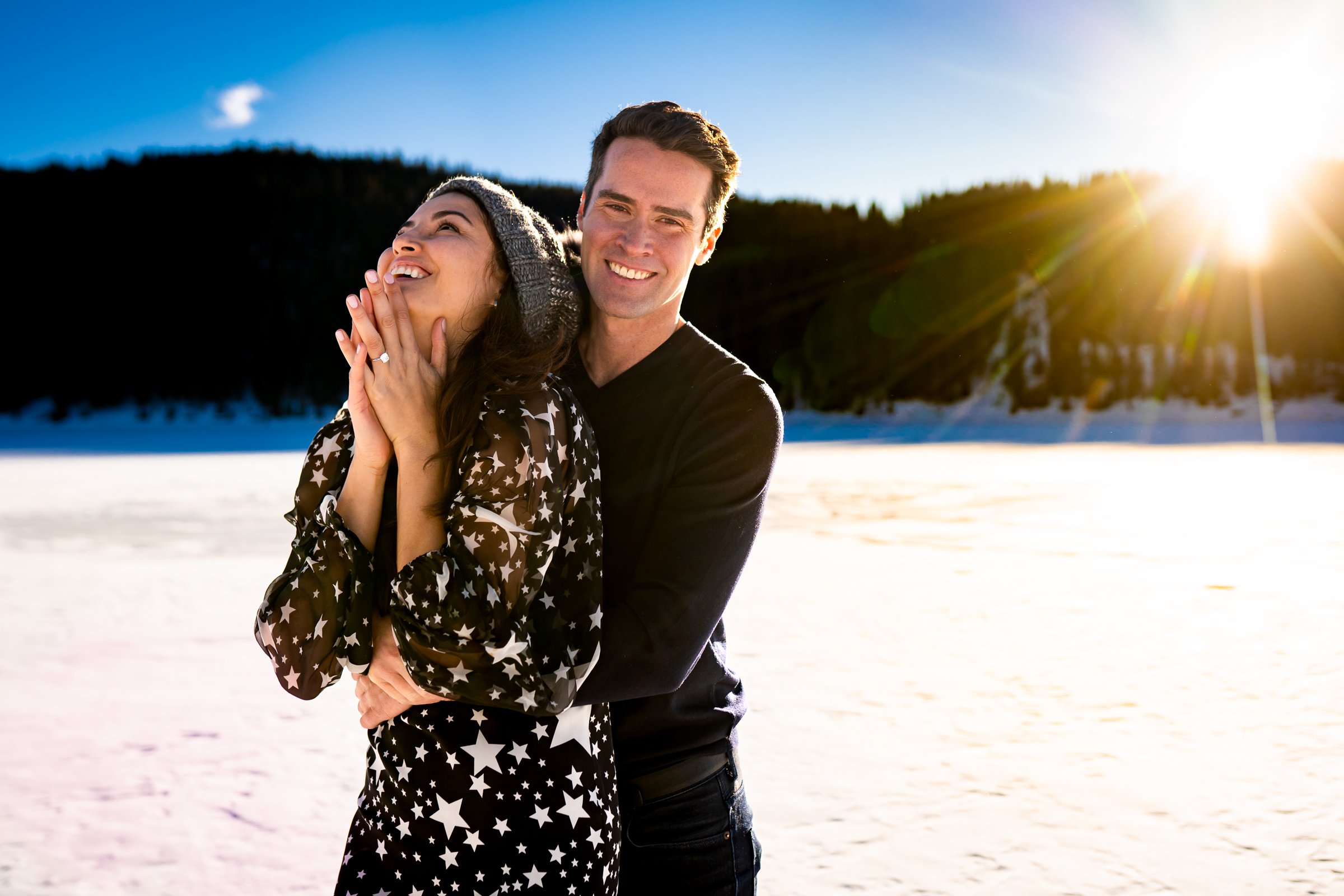 Newly engaged couple celebrate their proposal on a frozen lake with snowcapped mountains in the background, Engagement Session, Engagement Photos, Engagement Photos Inspiration, Engagement Photography, Engagement Photographer, Winter Engagement Photos, Proposal Photos, Proposal Photographer, Proposal Photography, Winter Proposal, Mountain Proposal, Proposal Inspiration, Summit County engagement session, Summit County engagement photos, Summit County engagement photography, Summit County engagement photographer, Summit County engagement inspiration, Colorado engagement session, Colorado engagement photos, Colorado engagement photography, Colorado engagement photographer, Colorado engagement inspiration, Clinton Gulch Engagement