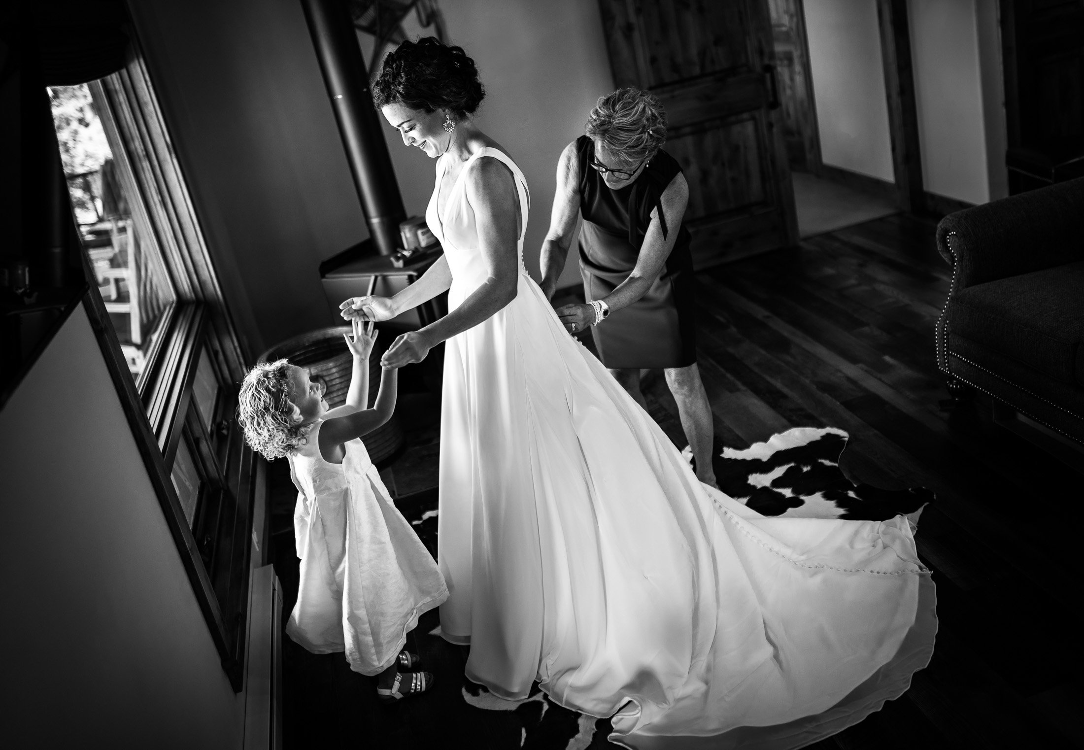 Bride gets into her wedding gown as she plays with her niece at her family's home in the mountains, wedding, wedding photos, wedding photography, wedding photographer, wedding inspiration, wedding photo inspiration, wedding portraits, wedding ceremony, wedding reception, mountain wedding, Catholic Church wedding, Catholic Church wedding photos, Catholic Church wedding photography, Catholic Church wedding photographer, Catholic Church wedding inspiration, Catholic Church wedding venue, Steamboat Springs wedding, Steamboat Springs wedding photos, Steamboat Springs wedding photography, Steamboat Springs wedding photographer, Colorado wedding, Colorado wedding photos, Colorado wedding photography, Colorado wedding photographer, Colorado mountain wedding, Colorado wedding inspiration