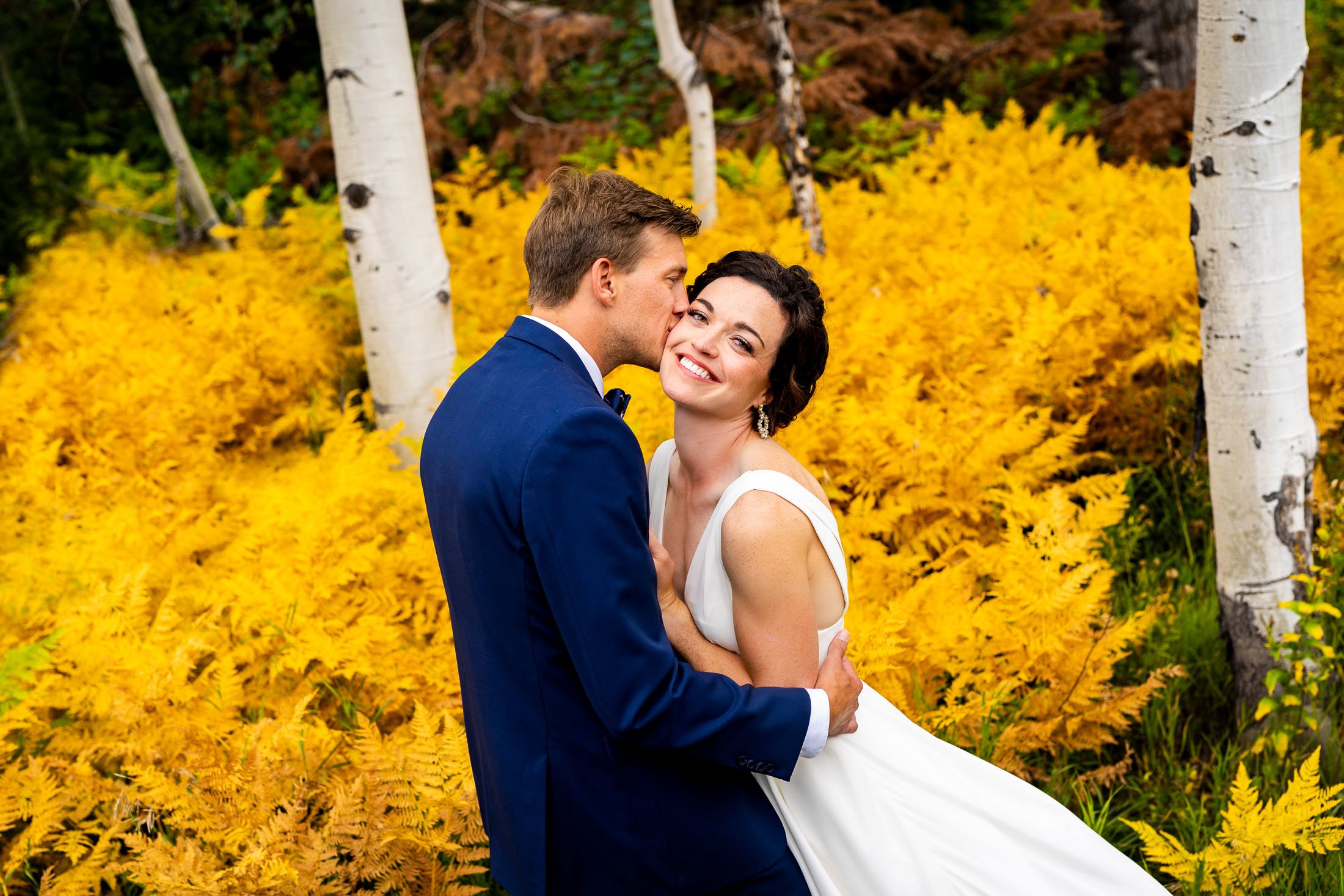 Bride and groom pose for a portrait in a field of golden ferns surrounded by aspens in a meadow, wedding, wedding photos, wedding photography, wedding photographer, wedding inspiration, wedding photo inspiration, wedding portraits, wedding ceremony, wedding reception, mountain wedding, Catholic Church wedding, Catholic Church wedding photos, Catholic Church wedding photography, Catholic Church wedding photographer, Catholic Church wedding inspiration, Catholic Church wedding venue, Steamboat Springs wedding, Steamboat Springs wedding photos, Steamboat Springs wedding photography, Steamboat Springs wedding photographer, Colorado wedding, Colorado wedding photos, Colorado wedding photography, Colorado wedding photographer, Colorado mountain wedding, Colorado wedding inspiration