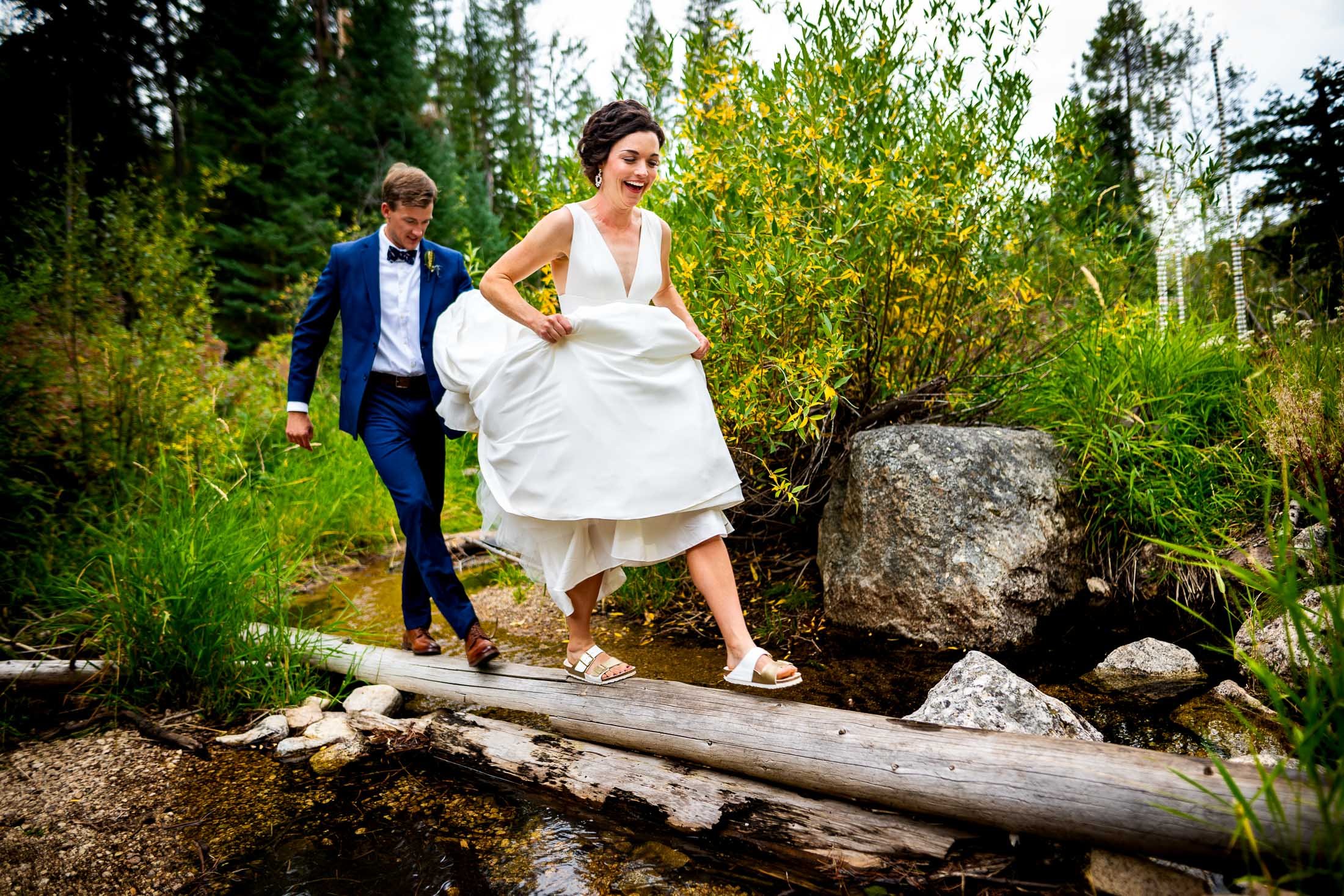 Bride and groom walk together over fallen logs in a forest, wedding, wedding photos, wedding photography, wedding photographer, wedding inspiration, wedding photo inspiration, wedding portraits, wedding ceremony, wedding reception, mountain wedding, Catholic Church wedding, Catholic Church wedding photos, Catholic Church wedding photography, Catholic Church wedding photographer, Catholic Church wedding inspiration, Catholic Church wedding venue, Steamboat Springs wedding, Steamboat Springs wedding photos, Steamboat Springs wedding photography, Steamboat Springs wedding photographer, Colorado wedding, Colorado wedding photos, Colorado wedding photography, Colorado wedding photographer, Colorado mountain wedding, Colorado wedding inspiration