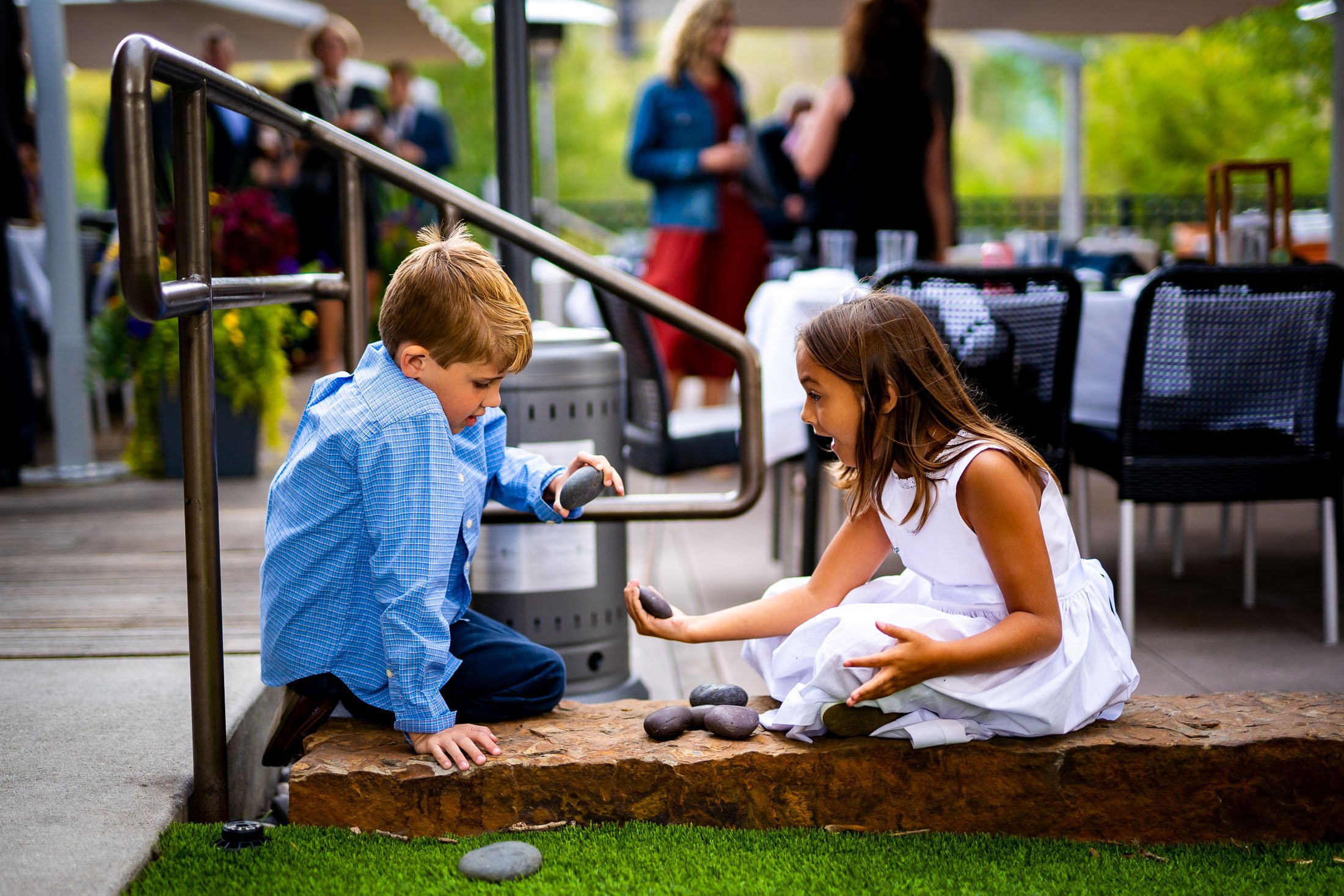 Wedding guests mingle on an outdoor patio during cocktail hour, wedding, wedding photos, wedding photography, wedding photographer, wedding inspiration, wedding photo inspiration, wedding portraits, wedding ceremony, wedding reception, mountain wedding, Catholic Church wedding, Catholic Church wedding photos, Catholic Church wedding photography, Catholic Church wedding photographer, Catholic Church wedding inspiration, Catholic Church wedding venue, Steamboat Springs wedding, Steamboat Springs wedding photos, Steamboat Springs wedding photography, Steamboat Springs wedding photographer, Colorado wedding, Colorado wedding photos, Colorado wedding photography, Colorado wedding photographer, Colorado mountain wedding, Colorado wedding inspiration