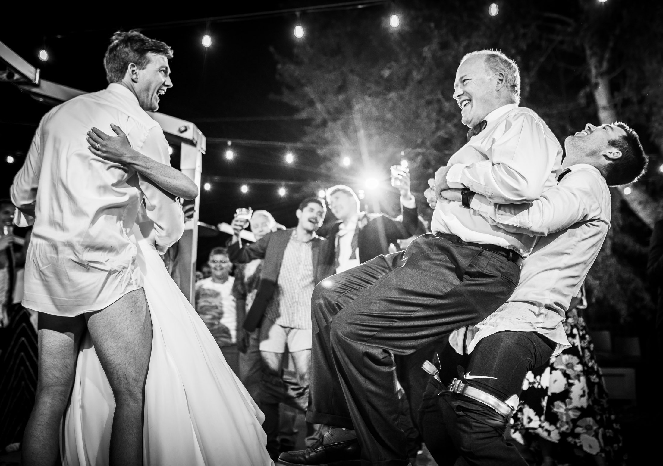 Bride and groom dance together while groom is wearing only his boxers on the outdoor patio under cafe lights during the wedding reception, wedding, wedding photos, wedding photography, wedding photographer, wedding inspiration, wedding photo inspiration, wedding portraits, wedding ceremony, wedding reception, mountain wedding, Catholic Church wedding, Catholic Church wedding photos, Catholic Church wedding photography, Catholic Church wedding photographer, Catholic Church wedding inspiration, Catholic Church wedding venue, Steamboat Springs wedding, Steamboat Springs wedding photos, Steamboat Springs wedding photography, Steamboat Springs wedding photographer, Colorado wedding, Colorado wedding photos, Colorado wedding photography, Colorado wedding photographer, Colorado mountain wedding, Colorado wedding inspiration