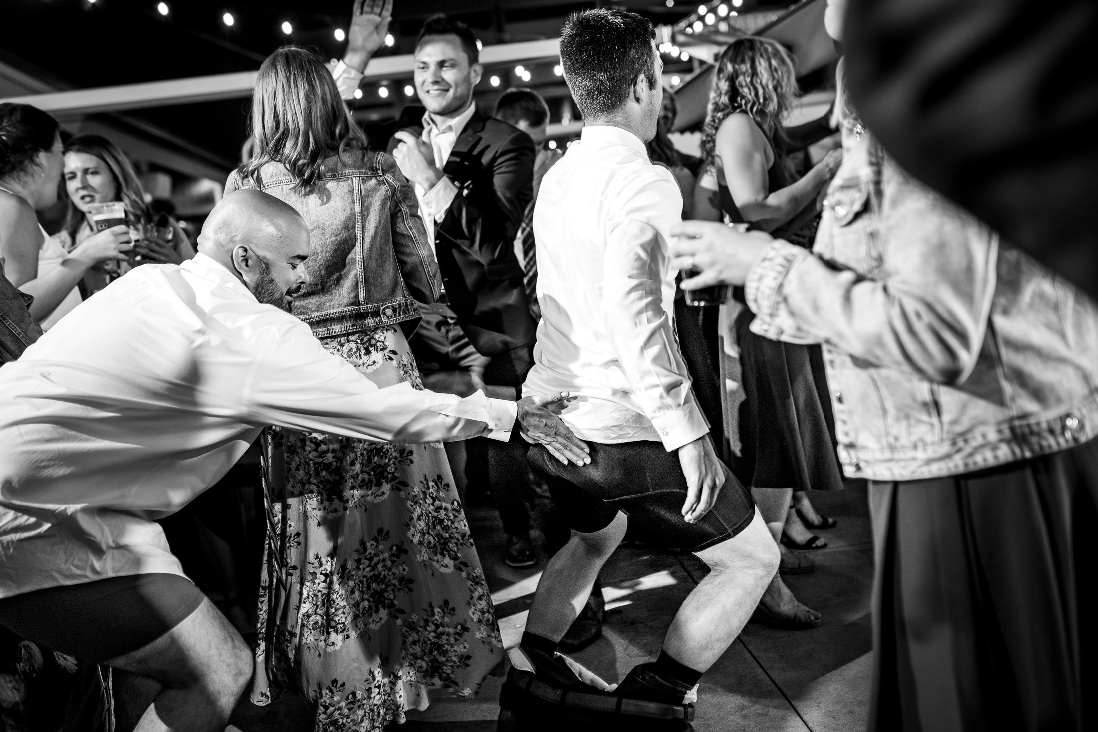 Bride and groom dance together while groom is wearing only his boxers on the outdoor patio under cafe lights during the wedding reception, wedding, wedding photos, wedding photography, wedding photographer, wedding inspiration, wedding photo inspiration, wedding portraits, wedding ceremony, wedding reception, mountain wedding, Catholic Church wedding, Catholic Church wedding photos, Catholic Church wedding photography, Catholic Church wedding photographer, Catholic Church wedding inspiration, Catholic Church wedding venue, Steamboat Springs wedding, Steamboat Springs wedding photos, Steamboat Springs wedding photography, Steamboat Springs wedding photographer, Colorado wedding, Colorado wedding photos, Colorado wedding photography, Colorado wedding photographer, Colorado mountain wedding, Colorado wedding inspiration