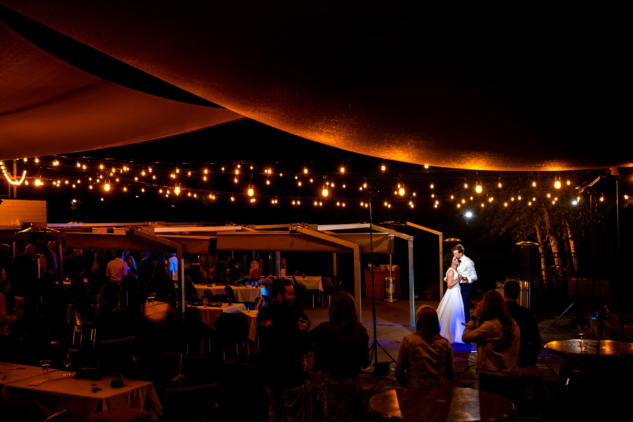 Guests dance to music on the outdoor patio under cafe lights during the wedding reception, wedding, wedding photos, wedding photography, wedding photographer, wedding inspiration, wedding photo inspiration, wedding portraits, wedding ceremony, wedding reception, mountain wedding, Catholic Church wedding, Catholic Church wedding photos, Catholic Church wedding photography, Catholic Church wedding photographer, Catholic Church wedding inspiration, Catholic Church wedding venue, Steamboat Springs wedding, Steamboat Springs wedding photos, Steamboat Springs wedding photography, Steamboat Springs wedding photographer, Colorado wedding, Colorado wedding photos, Colorado wedding photography, Colorado wedding photographer, Colorado mountain wedding, Colorado wedding inspiration