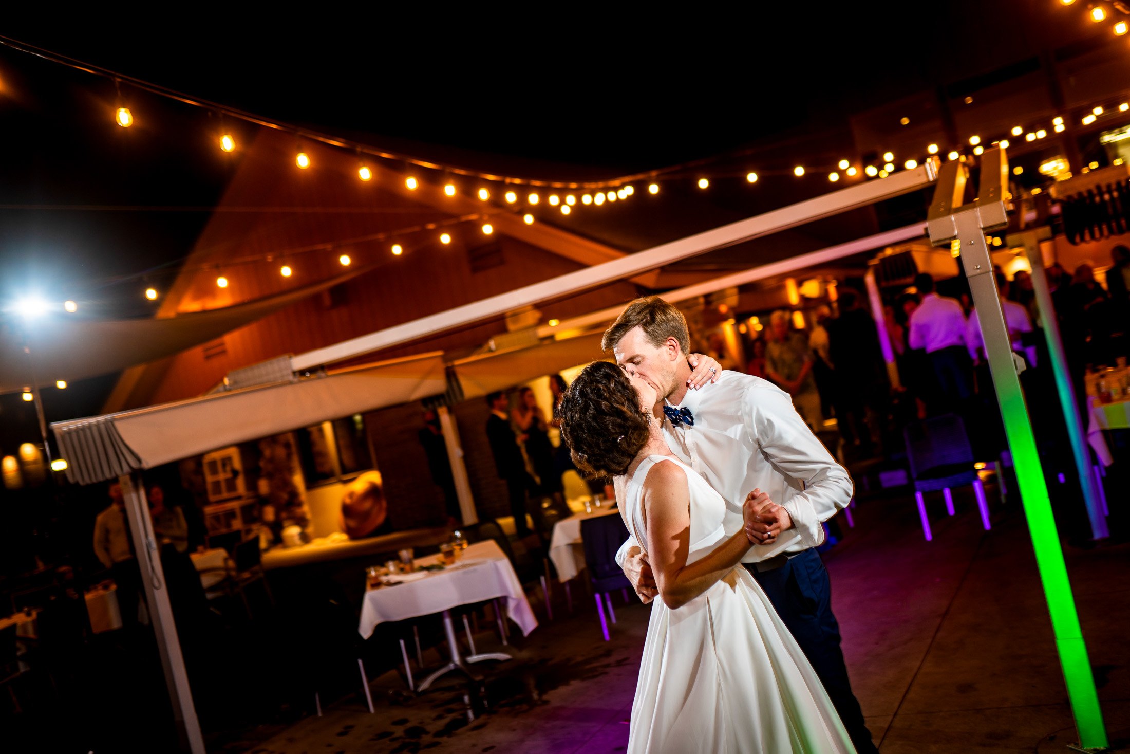 Guests dance to music on the outdoor patio under cafe lights during the wedding reception, wedding, wedding photos, wedding photography, wedding photographer, wedding inspiration, wedding photo inspiration, wedding portraits, wedding ceremony, wedding reception, mountain wedding, Catholic Church wedding, Catholic Church wedding photos, Catholic Church wedding photography, Catholic Church wedding photographer, Catholic Church wedding inspiration, Catholic Church wedding venue, Steamboat Springs wedding, Steamboat Springs wedding photos, Steamboat Springs wedding photography, Steamboat Springs wedding photographer, Colorado wedding, Colorado wedding photos, Colorado wedding photography, Colorado wedding photographer, Colorado mountain wedding, Colorado wedding inspiration